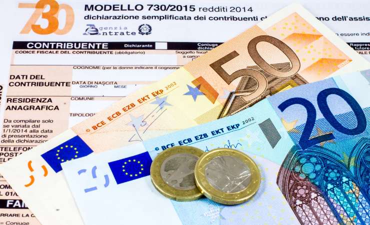 Monete e banconote poggiate su un modello 730
