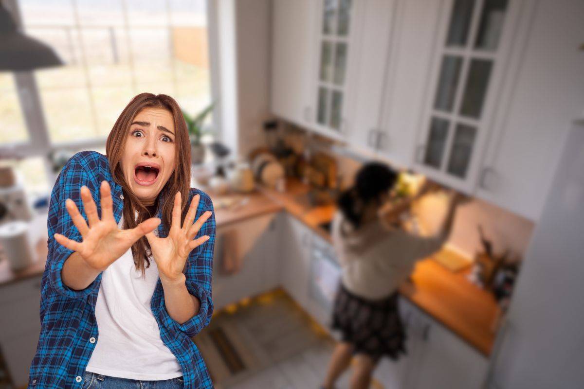 cucina sullo sfondo e donna spaventata
