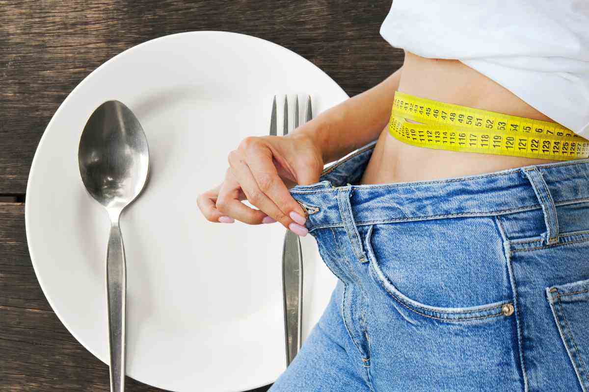 Piatto vuoto, donna che mostra dimagrimento