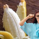 Ragazza con lente ingrandimento, sul fondo banana sbucciata
